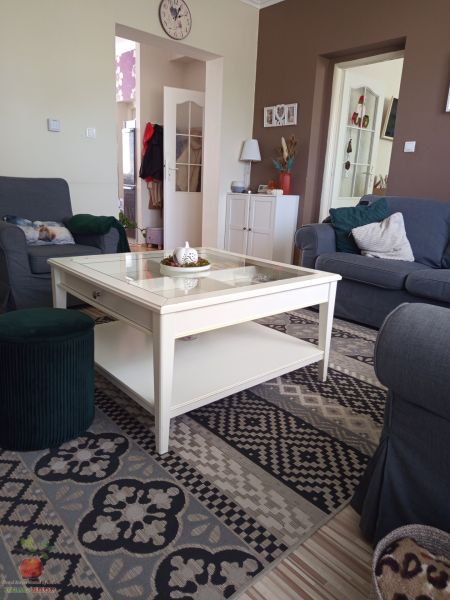 Living room in a 3-room apartment with a comfortable sofa and a patterned carpet.