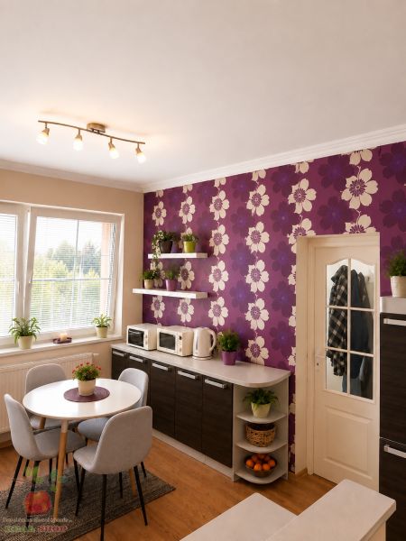 A kitchen in a 3-room apartment with purple wallpaper and a wooden decor floor.