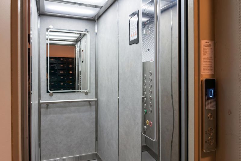 The interior of an elevator with a large mirror in a 3-room apartment.