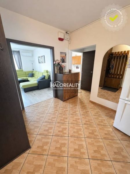Entrance hall in a 3-room apartment with tiles leading to the living room and kitchen.