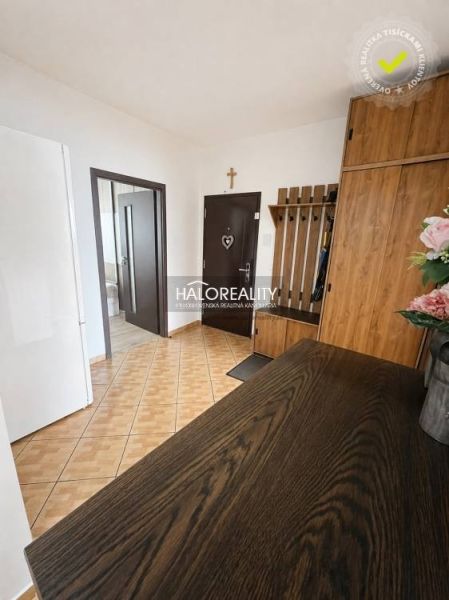 Hallway in a 3-room apartment with a wood-patterned floor and furniture.