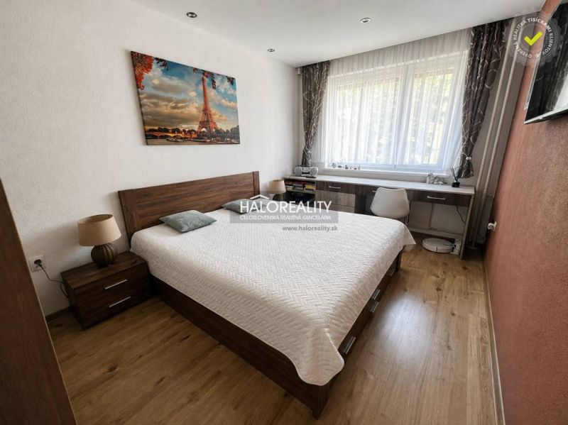 Bedroom in a 3-room apartment with wooden floor decor and a large window.