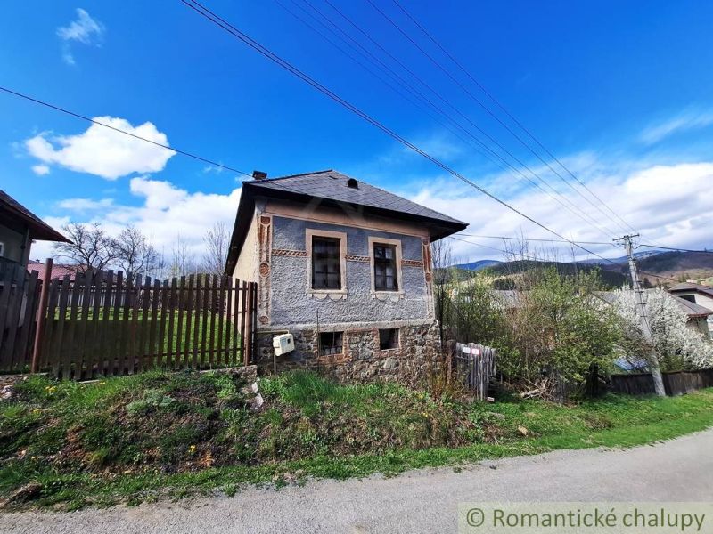 An old house with a decorated facade in the village of Heľpa, Unique properties on the hill.