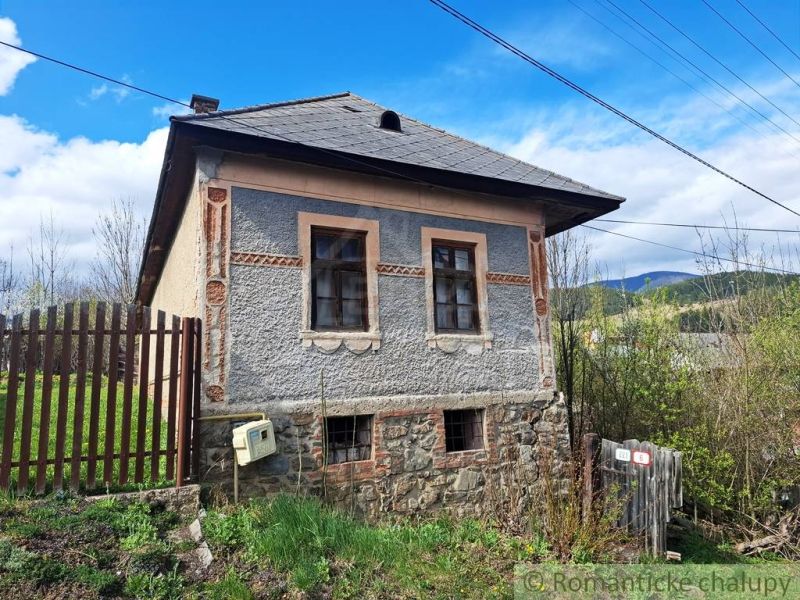 A unique property in the village of Heľpa with an older stone foundation and a colorful facade.