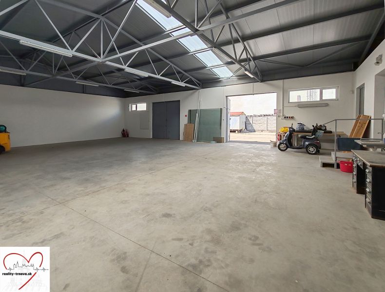 Interiors of warehouses and halls with concrete floors, skylights, and open doors.