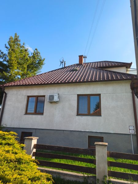 A family house in Zlaté Moravce with a sloped roof and a well-maintained garden.