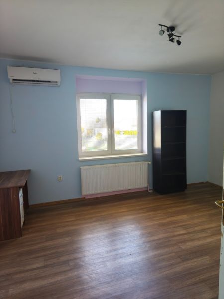 A room in a family house with a wooden decor floor and furniture.