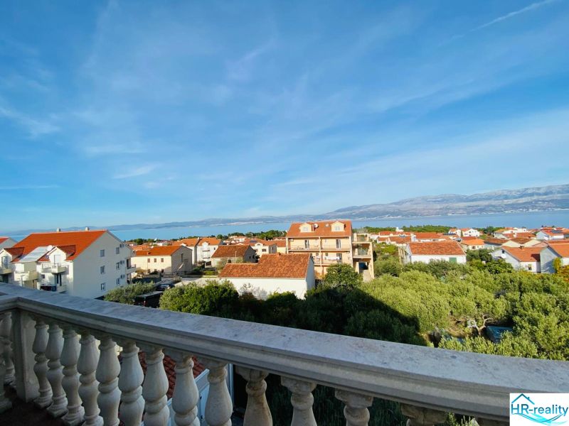 View from a holiday apartment in the town of Brač over the rooftops and the sea.