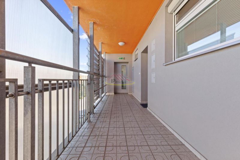 A hallway with an orange ceiling and railing, 2-room apartment.