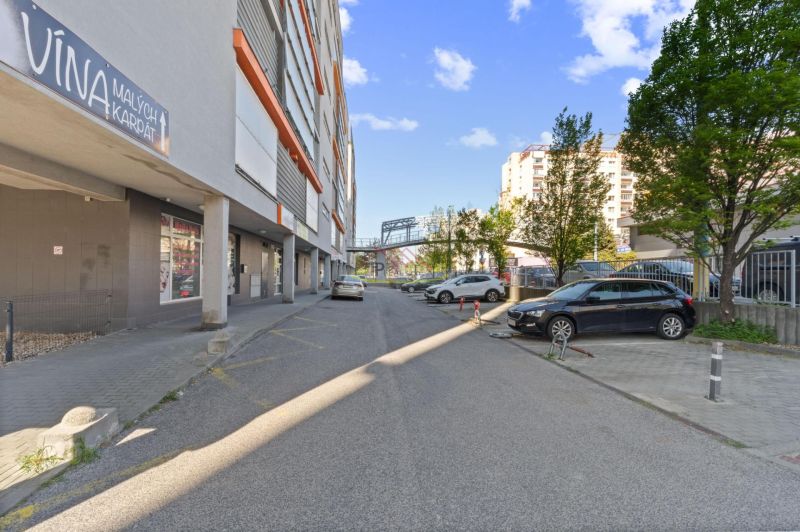 A view of Majerníkova Street in Bratislava - Karlova Ves with parking spaces.