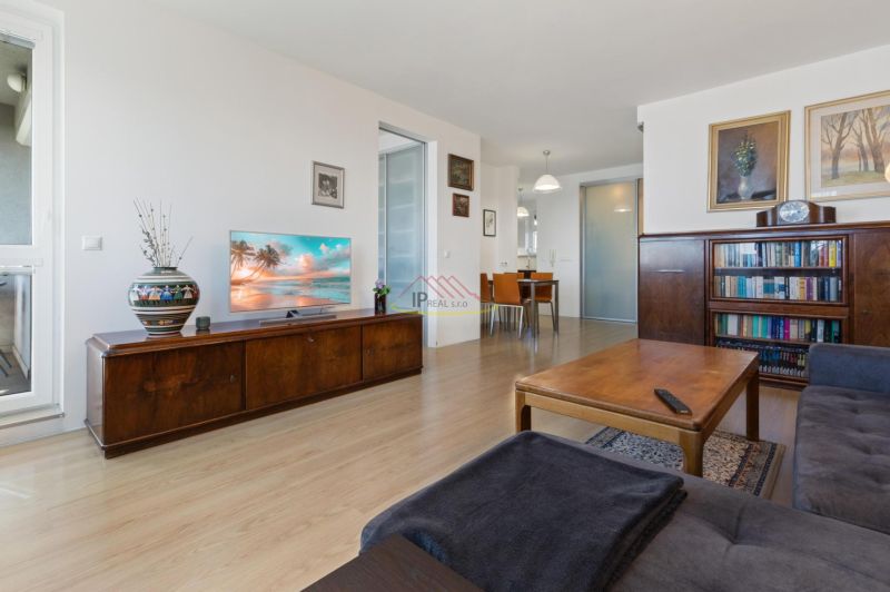 Living room with a sofa set, a table, and a wooden decor floor in a 2-room apartment.
