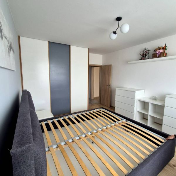 Bedroom in a 3-room apartment with a bed and a built-in wardrobe.