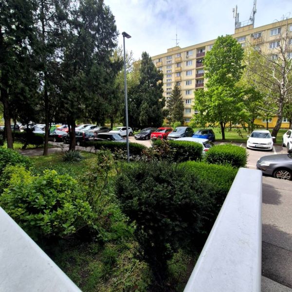 A view of the parking lot and residential block on Čmelíkova in Bratislava - Ružinov.