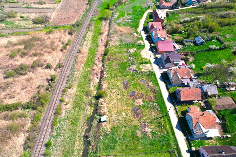 Railway track and houses lining the road in Hodejov, plots - living in a green environment.