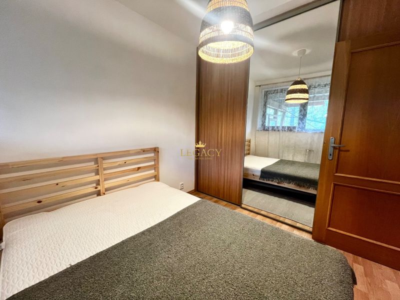 A bedroom in a 3-room apartment with a double bed and a wardrobe with sliding doors.