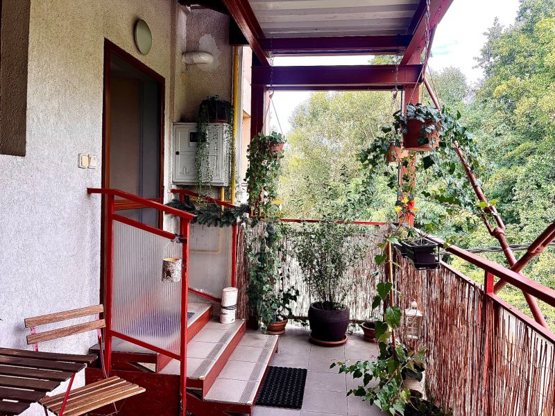 A balcony with plants in a 3-room apartment in Bernolákovo, view of greenery.
