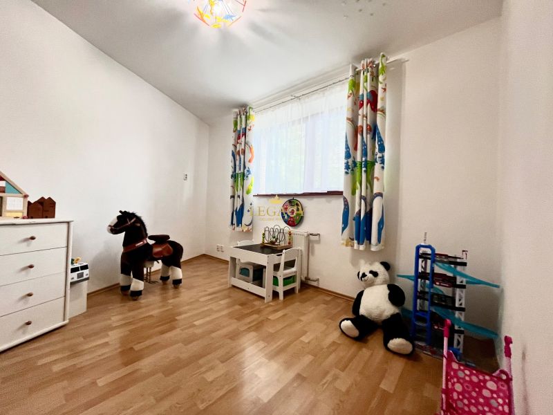 A children's room with toys and a wooden decor floor in a 3-room apartment.