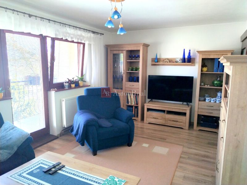 Living room in a family house with a comfortable armchair and a wooden decor floor.