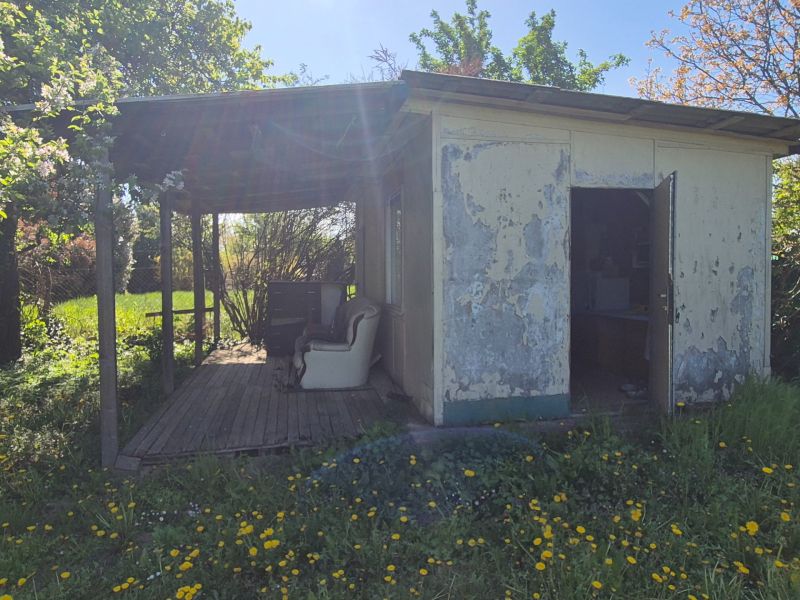 An older garden cottage surrounded by flowers on Vodná Street in Nitra.