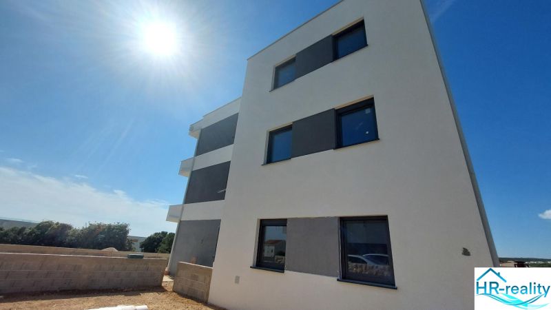 A recreational apartment in Novalja, a three-story building, sunny day, blue sky.