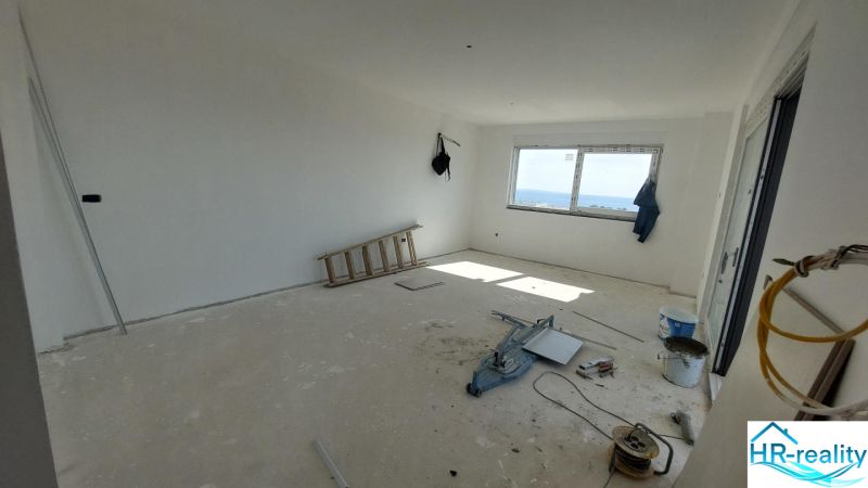 A recreational apartment under construction, with a sea view, containing tools and materials.