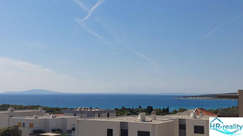 Recreational apartment in Novalja with a view of the sea and greenery.