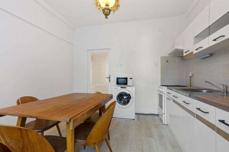 Kitchen in a 3-room apartment with a dining table and kitchen unit.