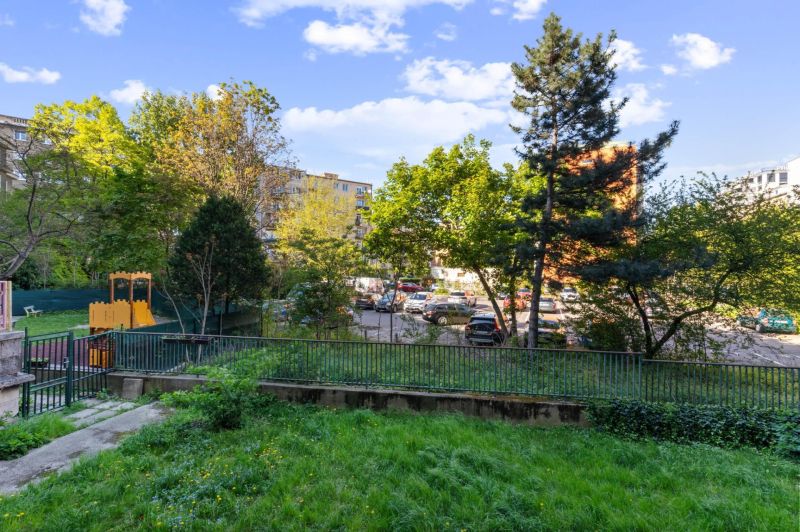 Garden with a playground, greenery surrounded by apartment buildings on Tabakova Street in Bratislava.