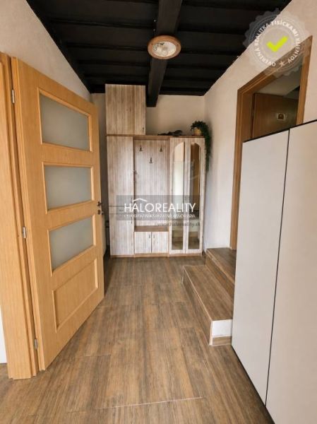 A hallway with stairs and a wooden decor floor in a family house.