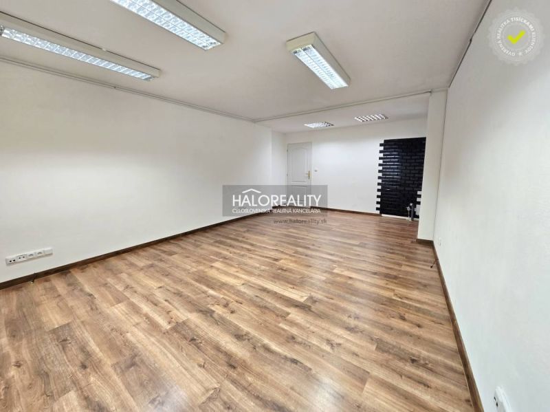 A room space with a wooden decor floor and white walls in a 3-room apartment.