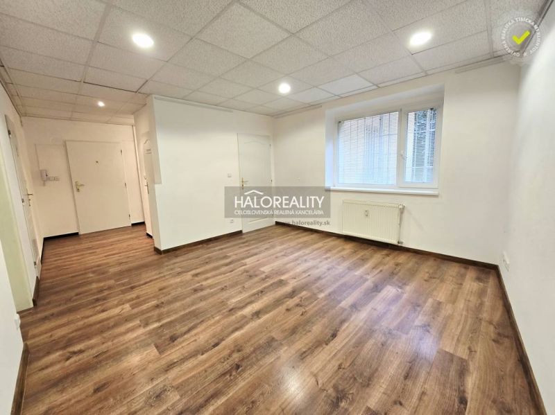 Interior of a 3-room apartment with wood-patterned flooring and white walls.