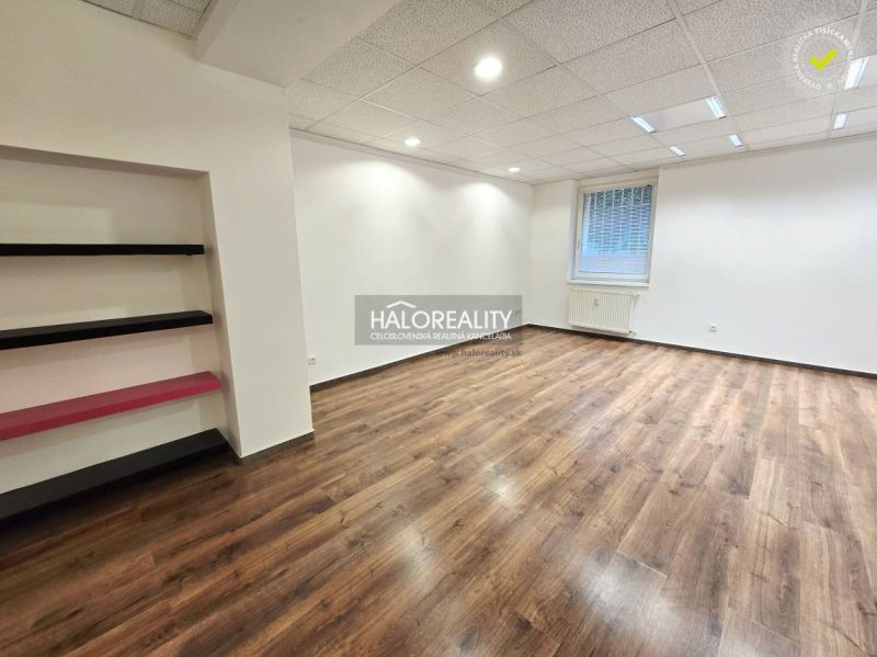 A room with a bright interior and a wooden decor floor in a 3-room apartment.