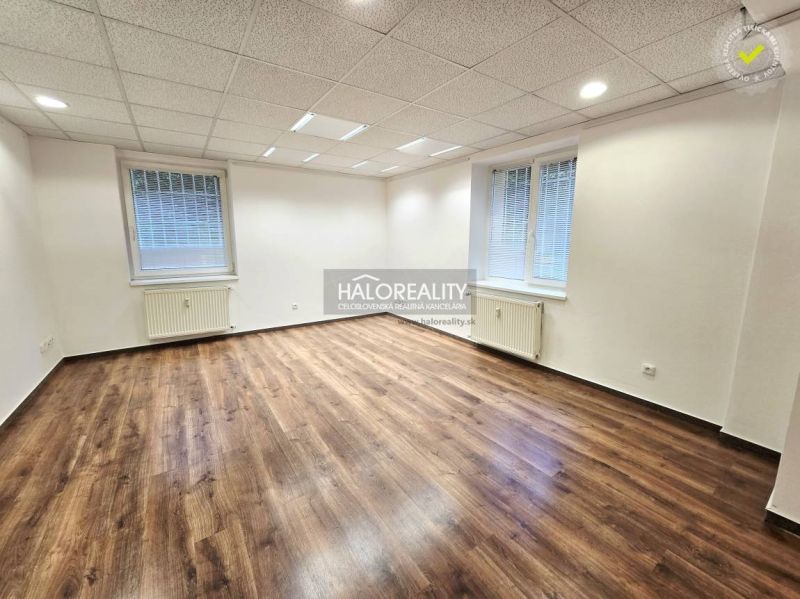 Floor plan of a 3-room apartment with wood-patterned flooring and modern furniture.