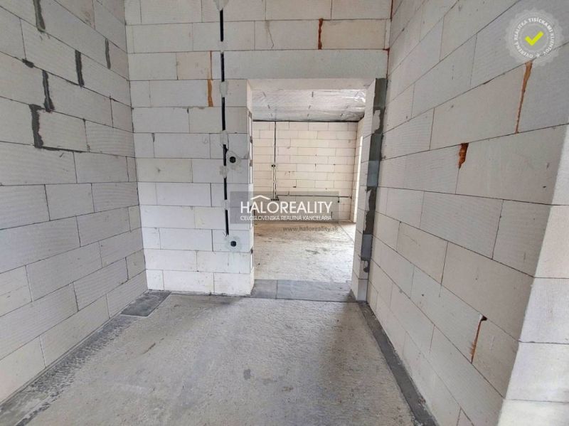 Empty room in a family house with unfinished walls and floor.