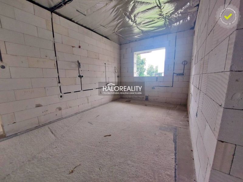 A room in a family house with raw walls, ready for completion.