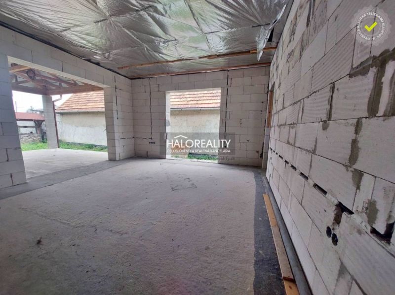 An unfinished interior of a family house with unbuilt walls and open spaces.