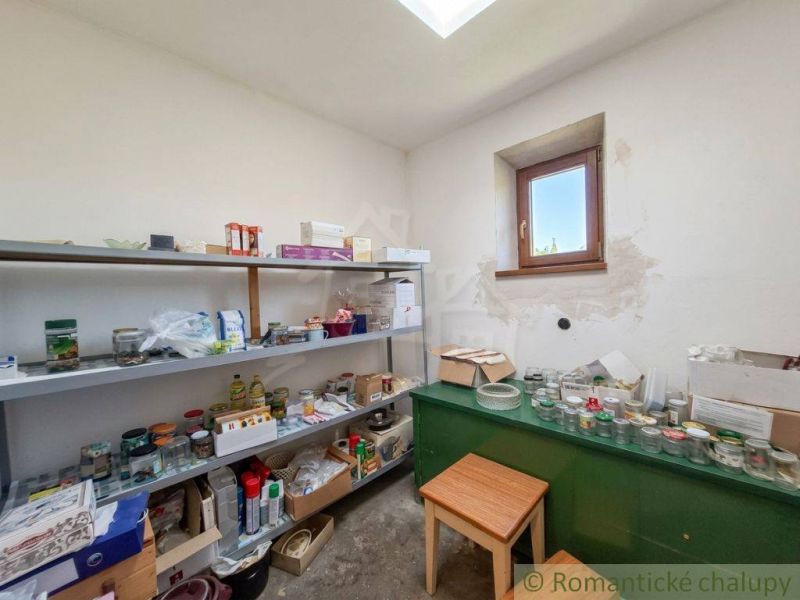 Pantry in a family house with shelves full of food and supplies.