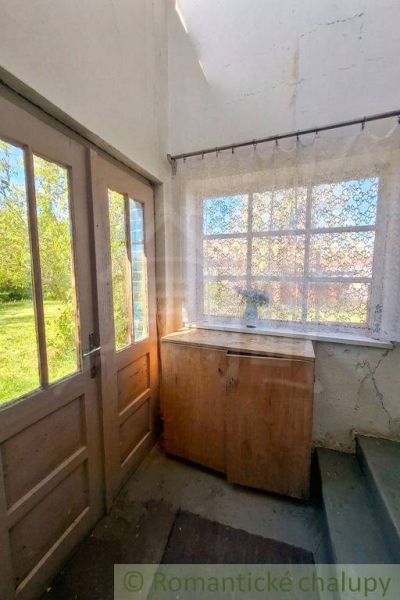 Entrance area of the family house with a wooden cabinet and beautiful glazing.