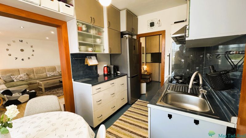 Kitchen with dining table, view into the living room, 3-room apartment.