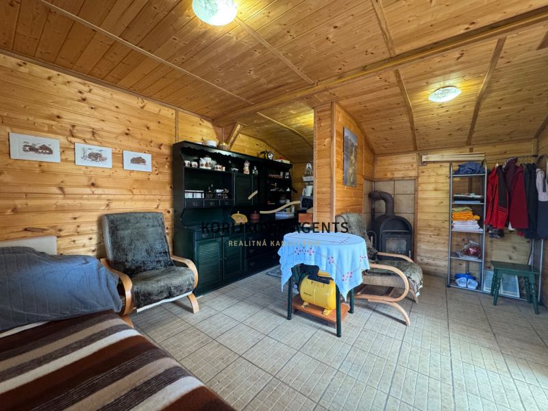 A cottage with a wooden decor floor, tiles, and comfortable furniture.