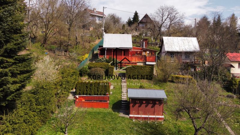 A cottage on Kavečianska Road in Košice, Sever district, surrounded by a garden and trees.