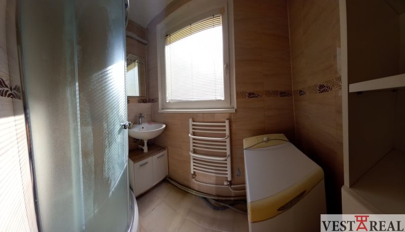 Bathroom in a 3-room apartment with a sink, shower, and washing machine.