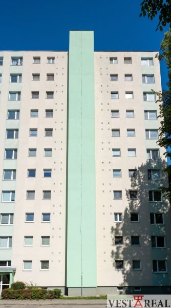 A building on Okružná Street in Trnava with multiple windows and a light facade.