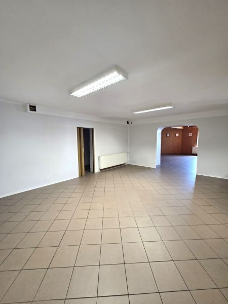 Spacious gastro premises with tiles and white walls, suitable for business.