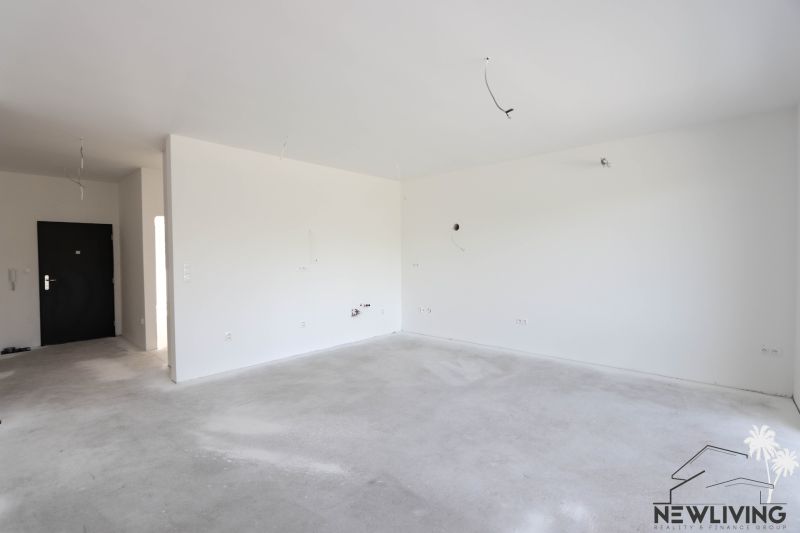 An empty 2-room apartment with white walls and entrance doors.