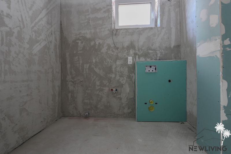 Unfinished bathroom in a 2-room apartment with a window and prepared installations.