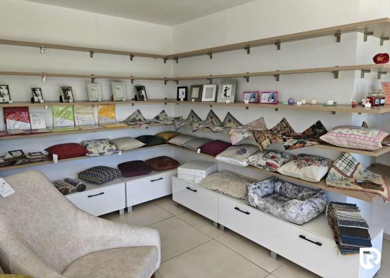 Retail spaces with decorative pillows, frames, and shelves.
