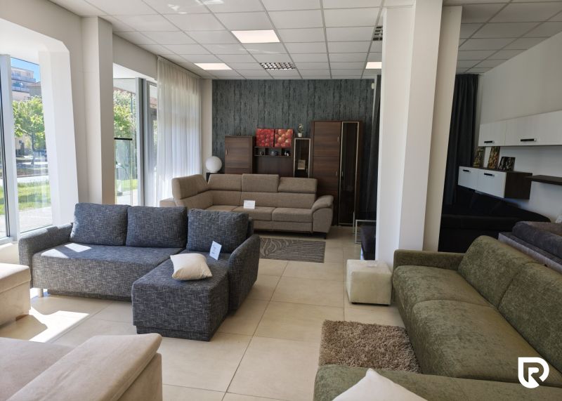 Interior of commercial spaces with displayed sofas and built-in furniture.