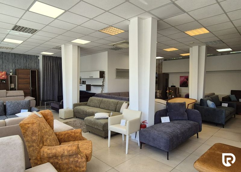 Commercial premises with sofas and armchairs and a floor with a wooden decor.