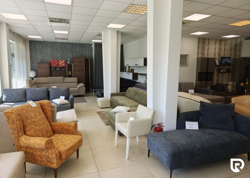 Commercial spaces filled with a variety of sofas and armchairs with white wall cladding.